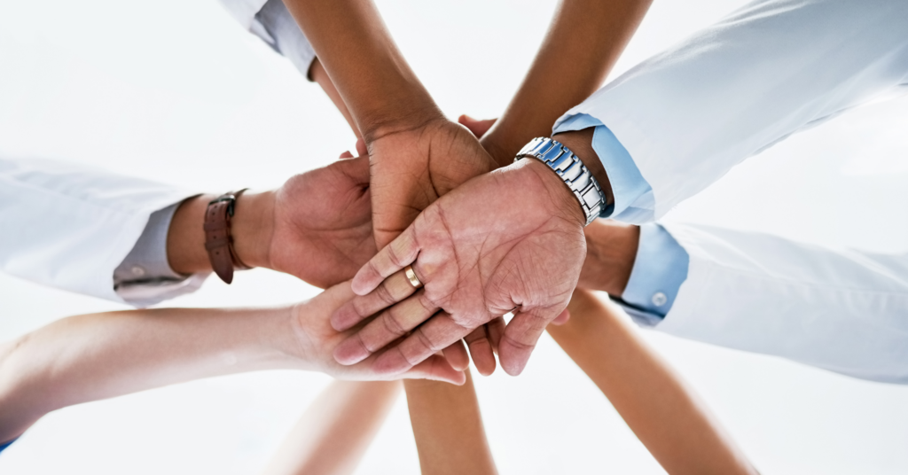 team of doctors joining hands in unity